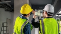 Employés de la construction observant un plan sur une tablette
